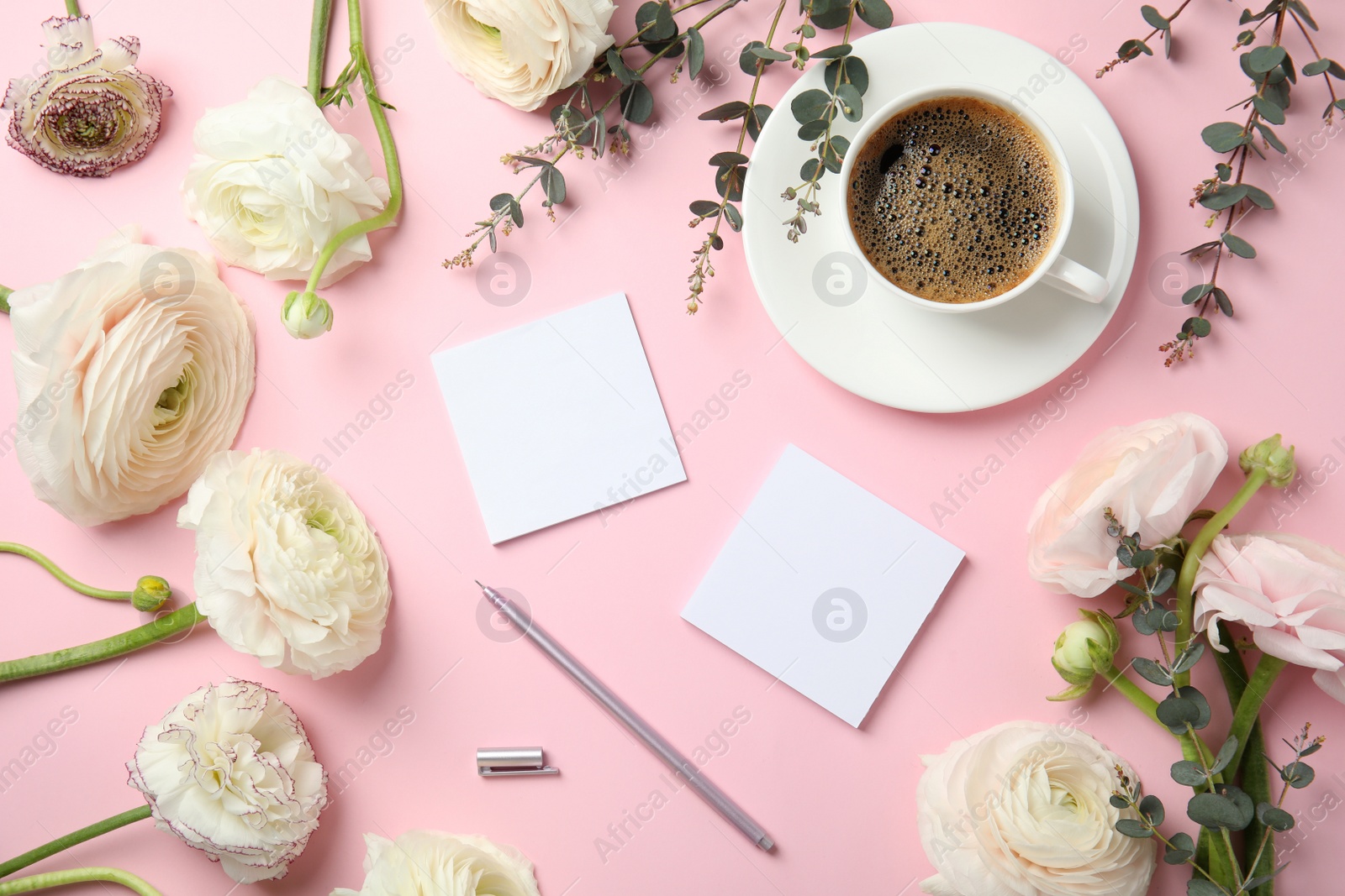 Photo of Flat lay composition with spring ranunculus flowers and cards on color background. Space for text