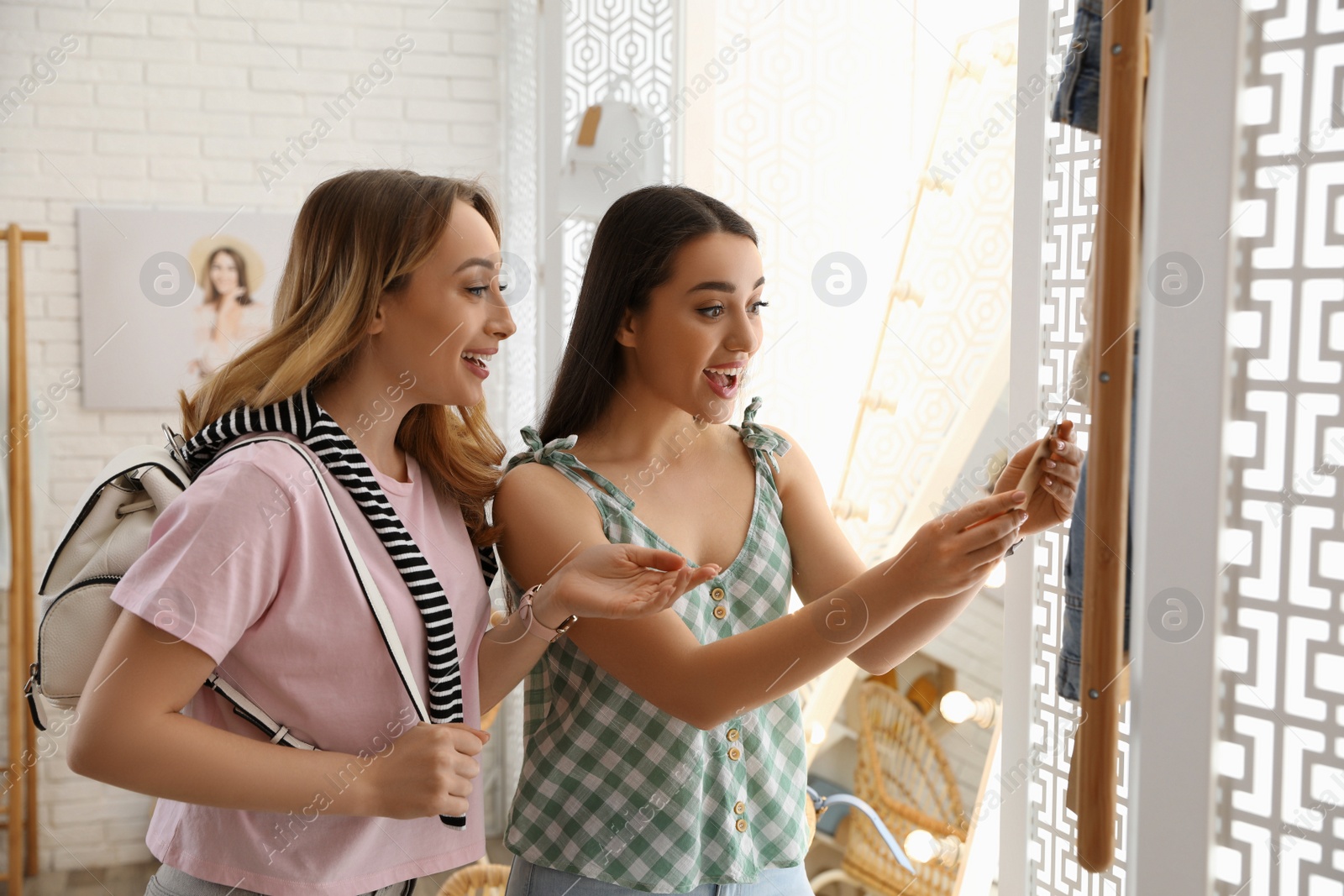 Photo of Women choosing jeans to buy in showroom