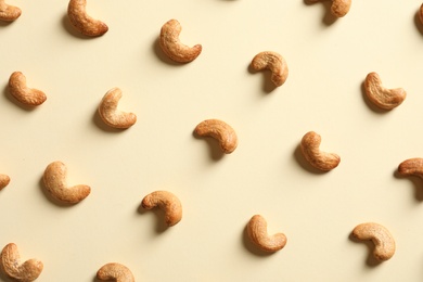 Photo of Tasty cashew nuts on light background, flat lay