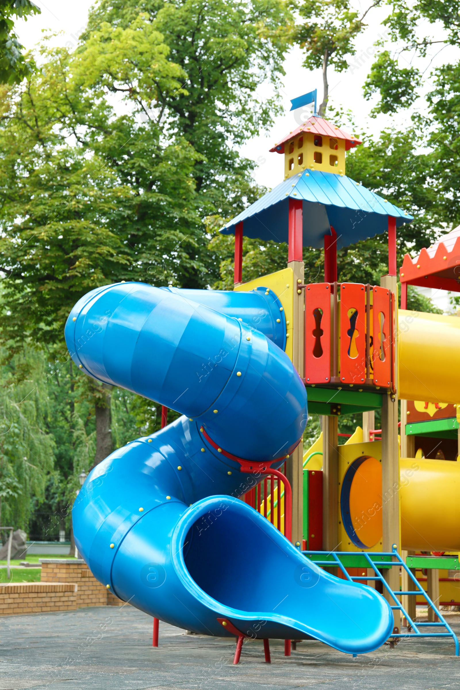 Photo of New colorful castle playhouse with slide on children's playground