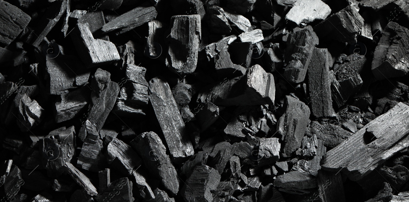 Photo of Heap of coal as background, top view