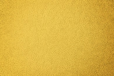 Image of Golden textured surface as background, closeup view