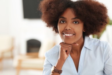 Portrait of smiling African American woman indoors. Space for text