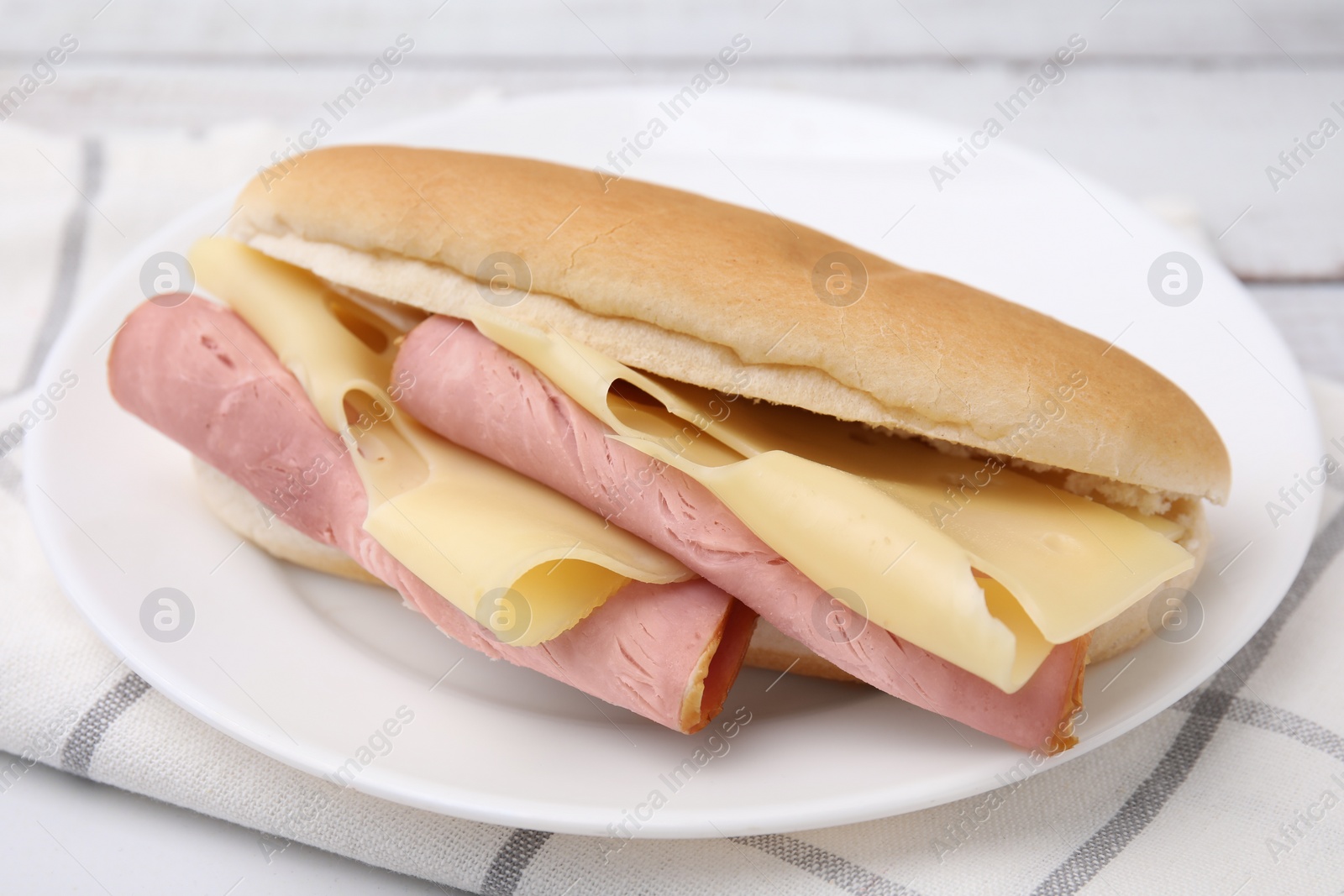 Photo of Delicious sandwich with ham and cheese on table, closeup