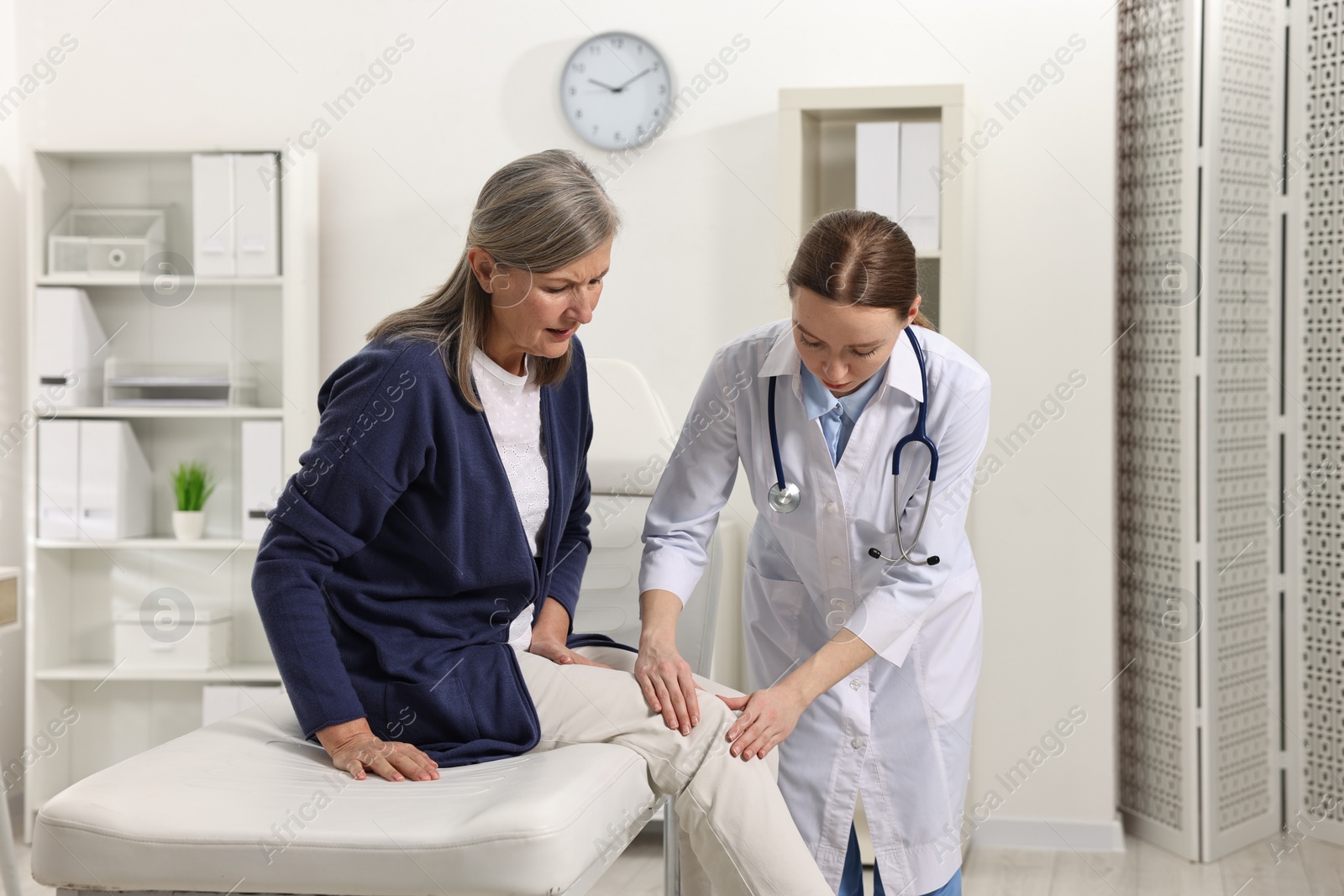 Photo of Arthritis symptoms. Doctor examining patient with knee pain in hospital