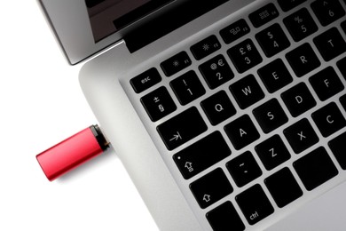 Photo of Usb flash drive attached into laptop on white background, above view