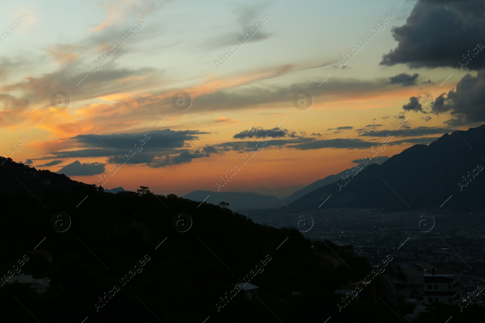 Photo of Picturesque view of big mountains under clouds in evening