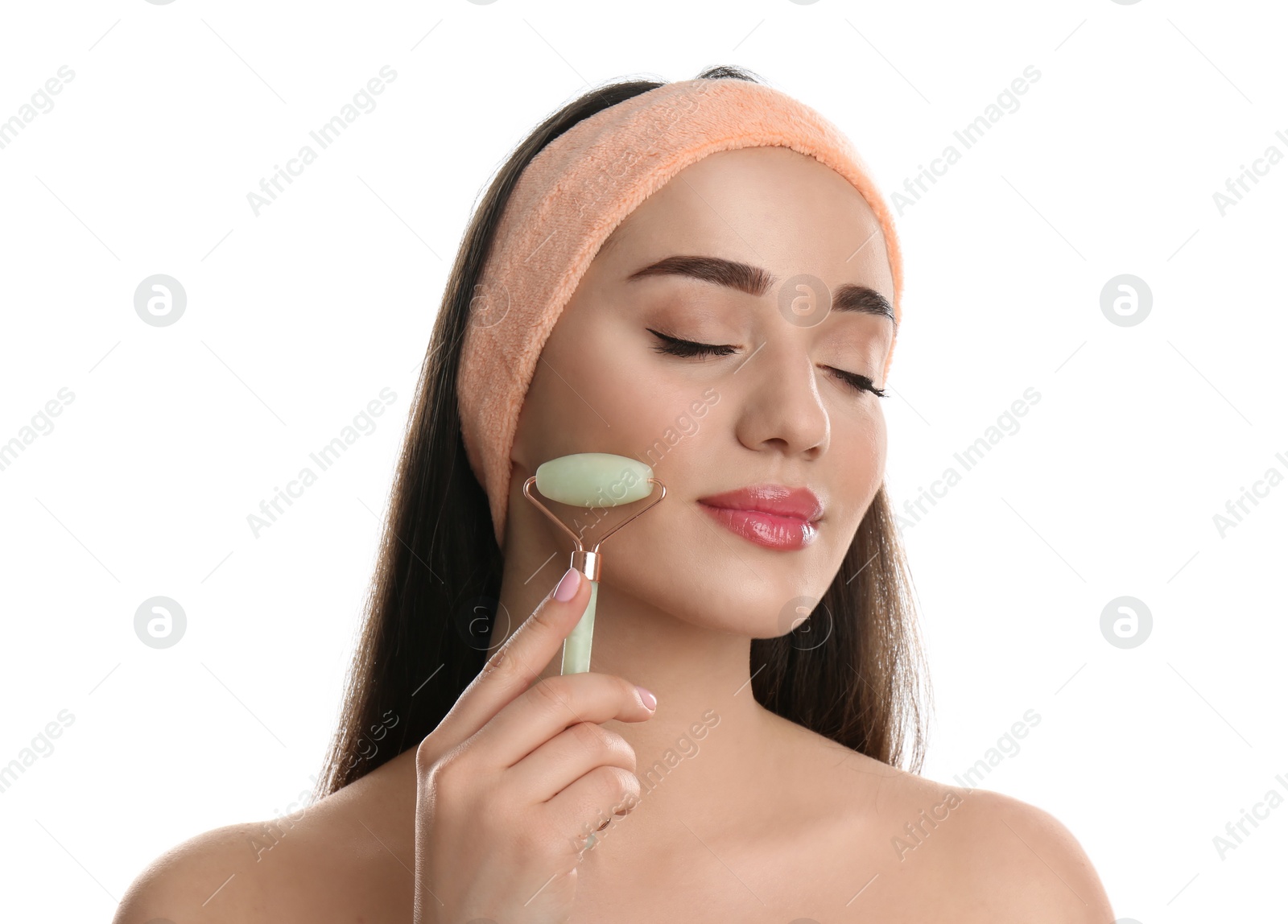 Photo of Woman using natural jade face roller on white background