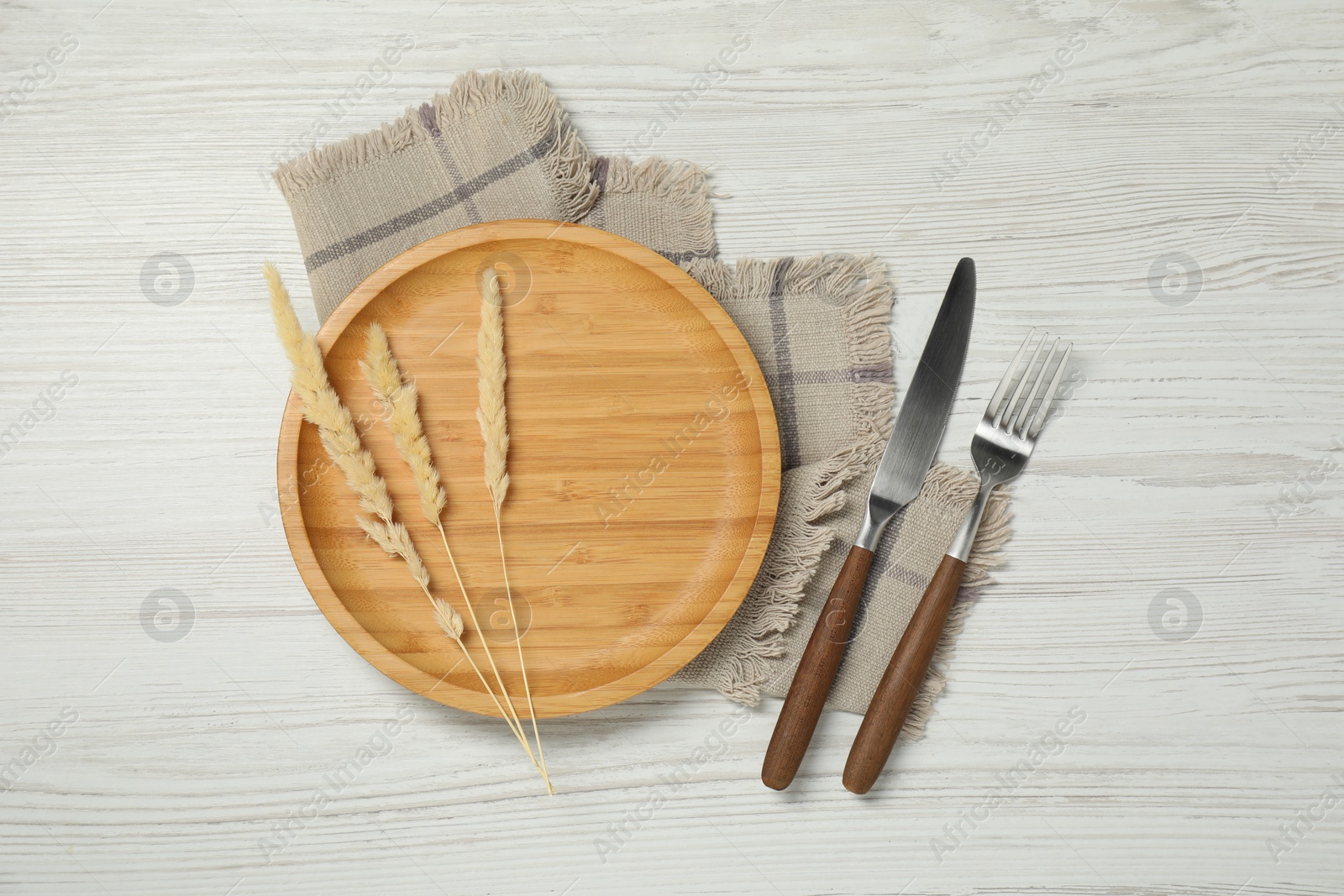 Photo of Stylish setting with elegant cutlery on white wooden table, top view