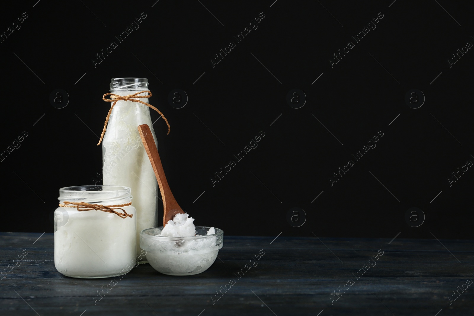 Photo of Fresh coconut oil on dark wooden table, space for text. Cooking ingredient