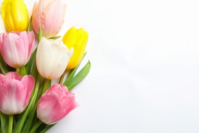 Photo of Beautiful spring tulips on white background, top view. International Women's Day