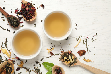 Flat lay composition with green tea on white wooden table