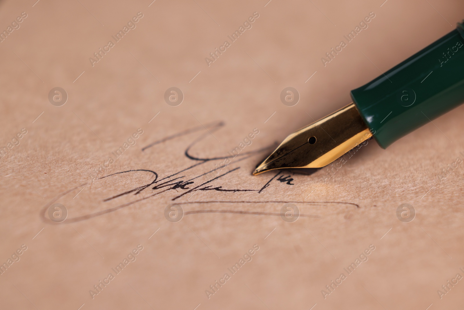 Photo of Signing on sheet of paper with fountain pen, closeup