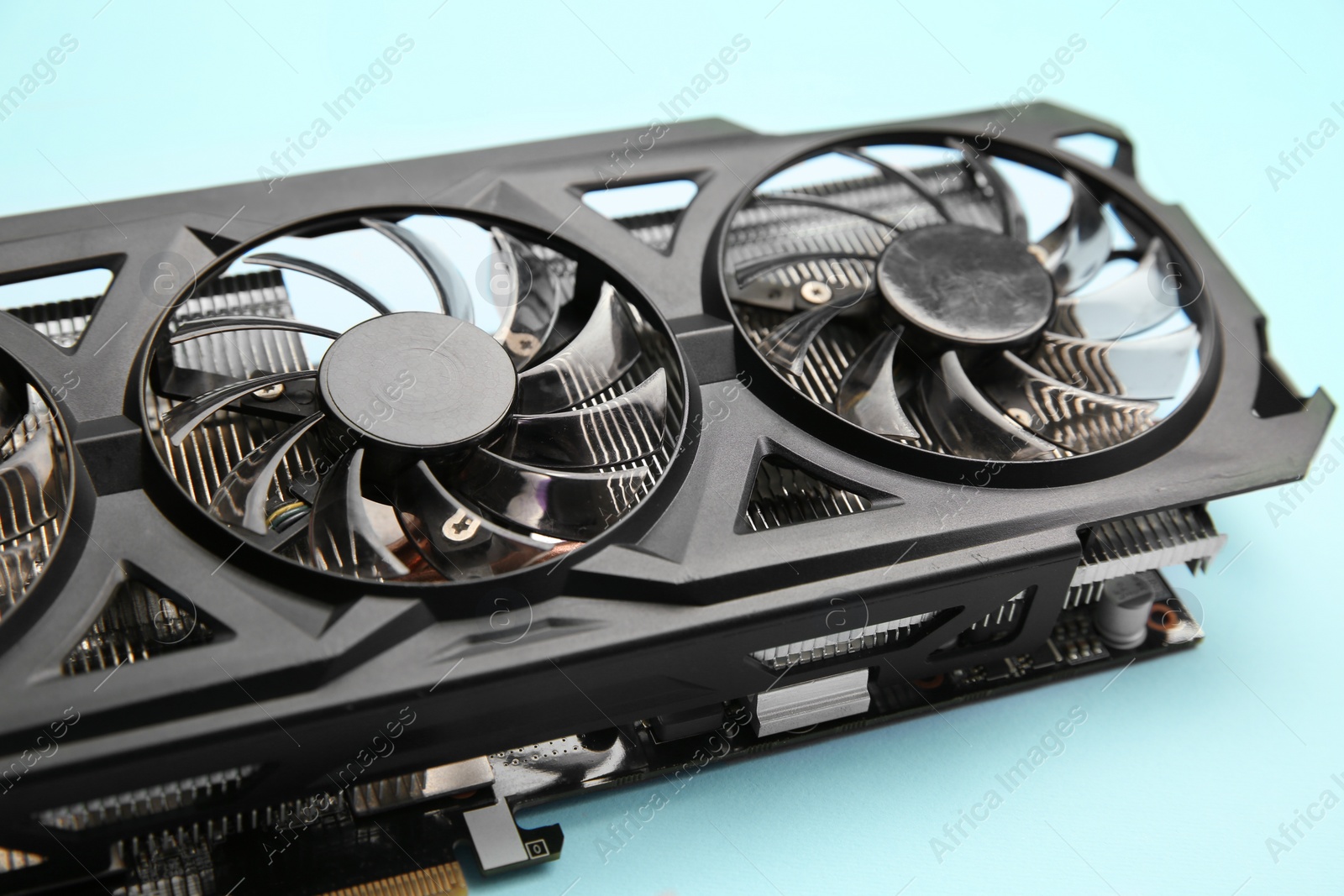 Photo of One graphics card on light blue background, closeup