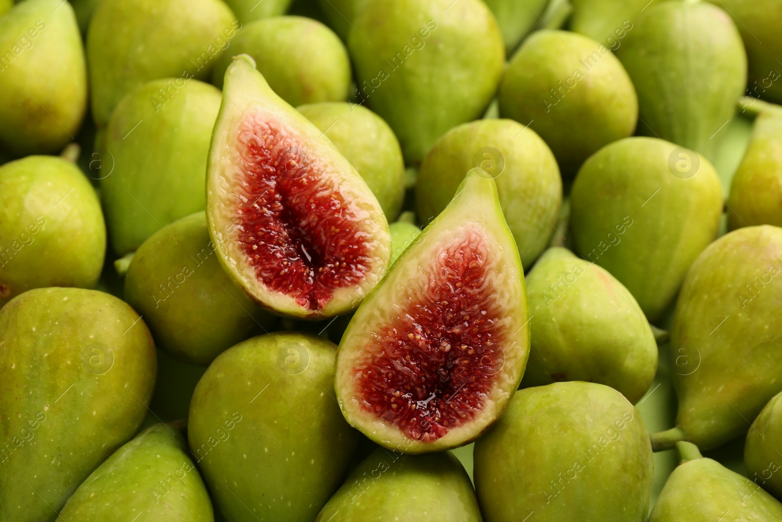 Photo of Halves of green fig on fresh fruits