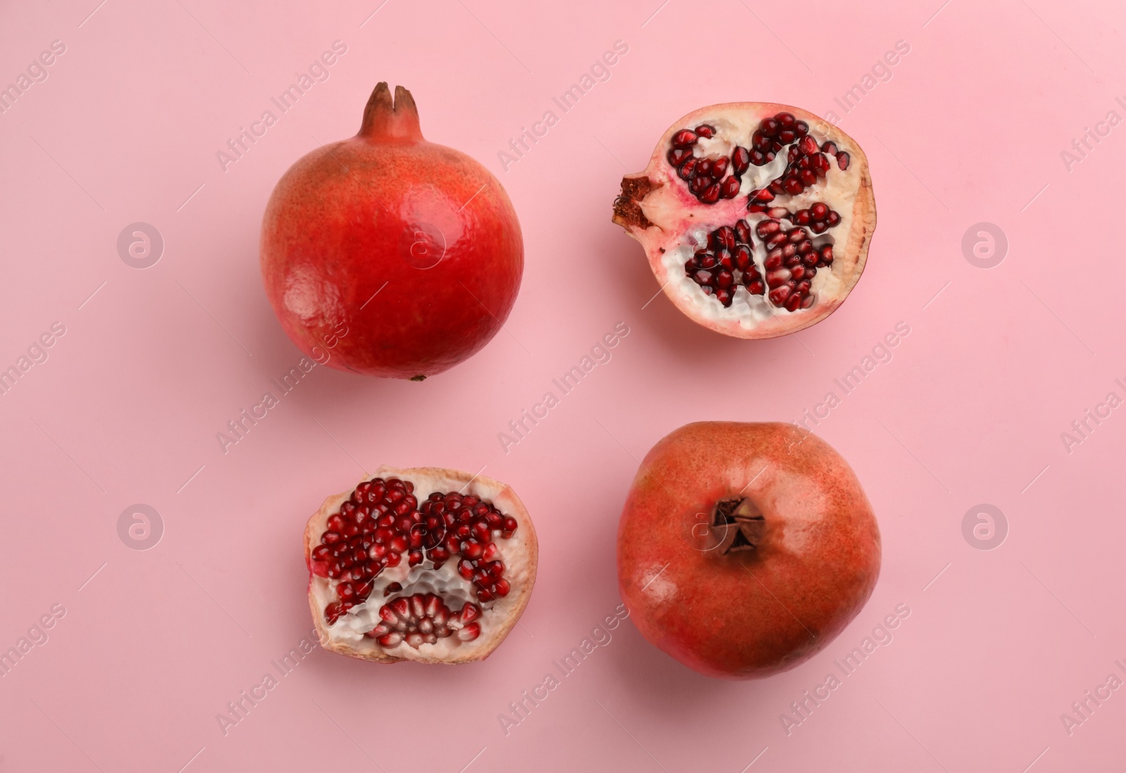 Photo of Flat lay composition with ripe pomegranates on pink background