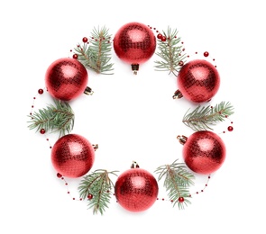 Beautiful Christmas wreath made of shiny red baubles, garland and fir branches on white background, top view