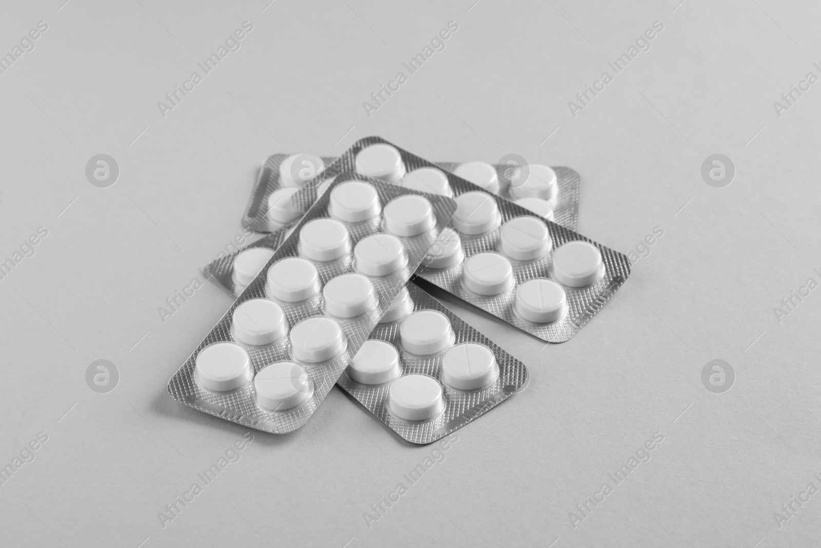 Photo of Blisters of pills on white background. Medicinal treatment