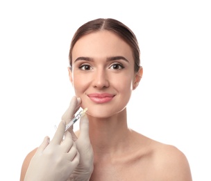 Beautiful woman getting facial injection on white background. Cosmetic surgery