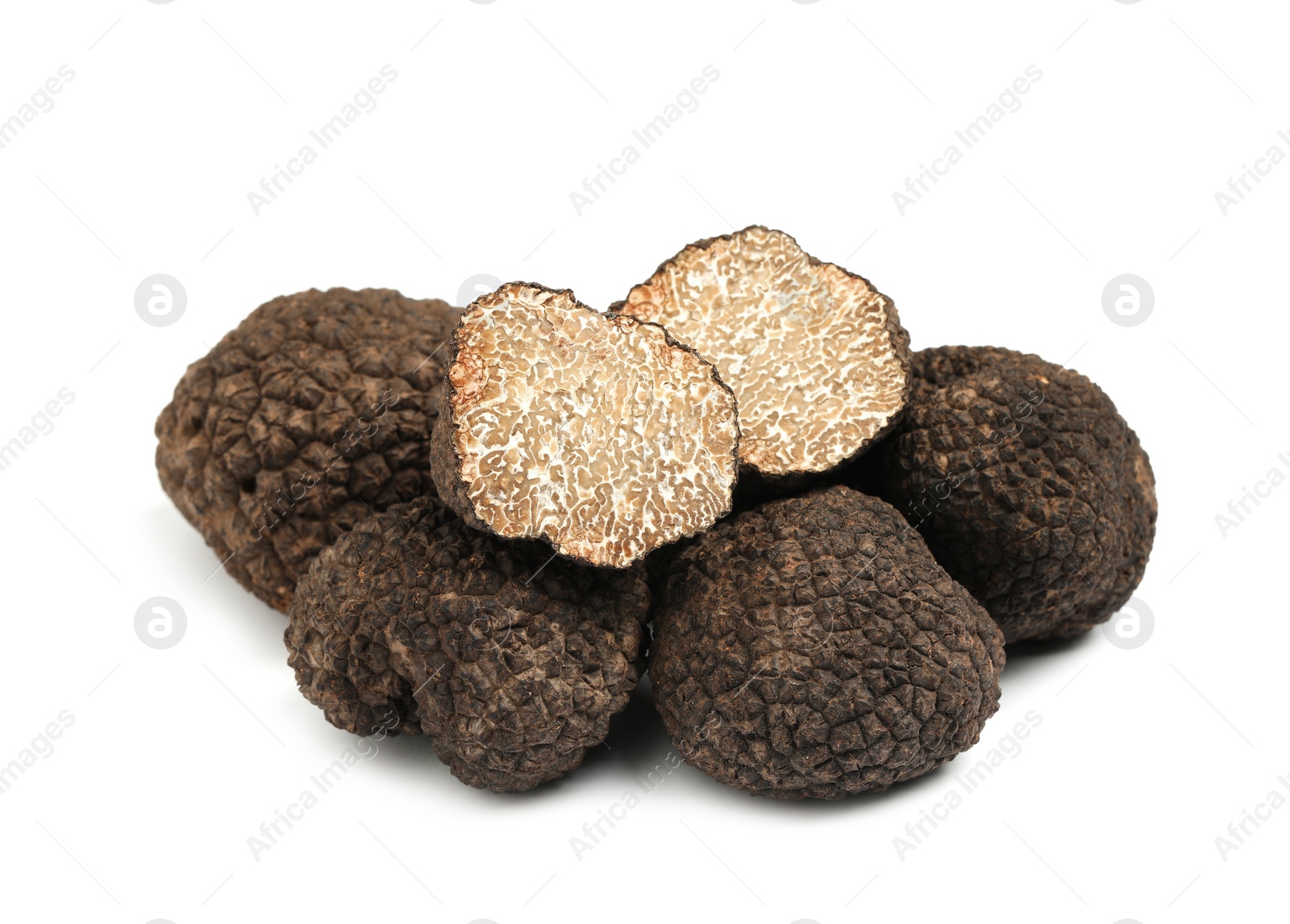 Photo of Cut and whole black truffles isolated on white