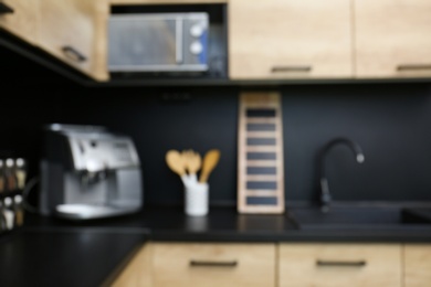 Blurred view of kitchen interior with modern furniture