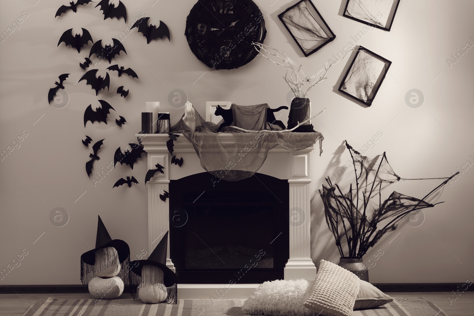 Photo of Stylish room with fireplace decorated for Halloween