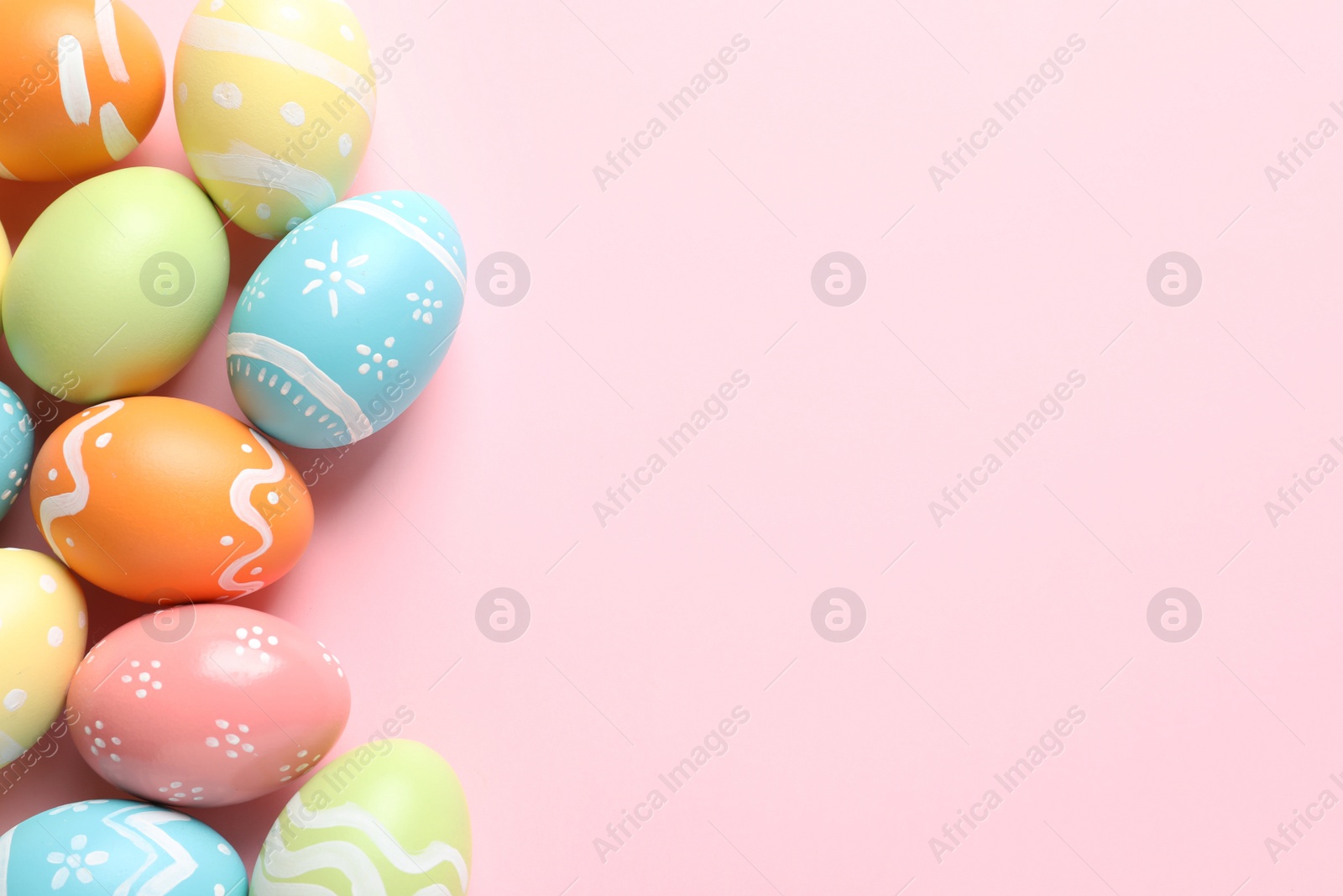 Photo of Many painted Easter eggs on color background, top view. Space for text