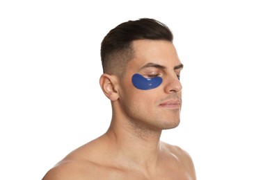 Man with blue under eye patches on white background