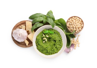 Photo of Fresh tasty pesto sauce and ingredients isolated on white, top view