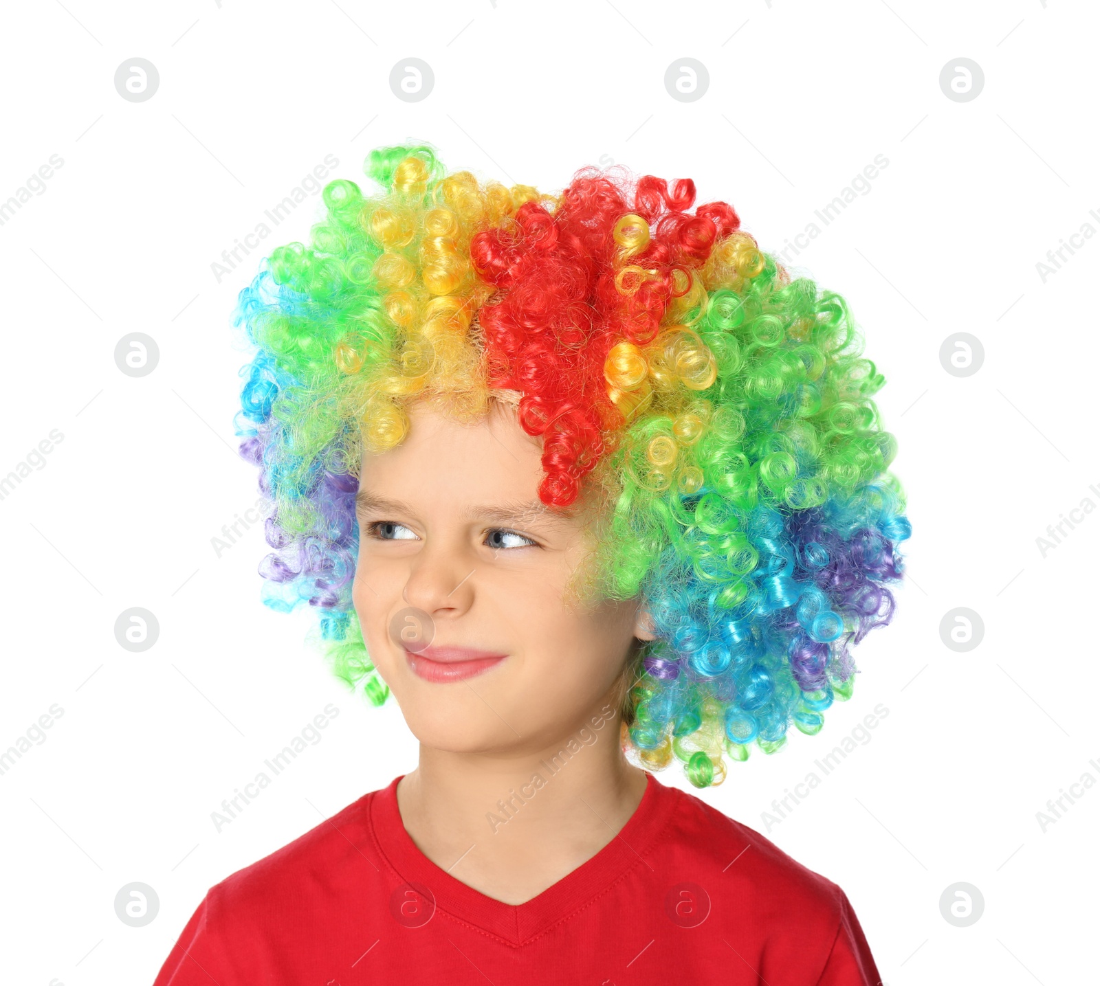 Photo of Little boy in clown wig on white background. April fool's day