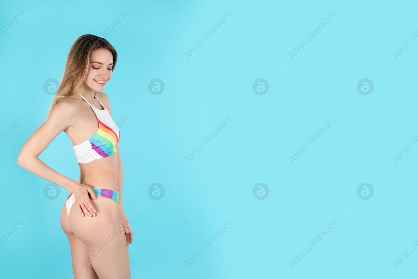 Photo of Young slim woman in bikini on color background, space for text. Perfect body