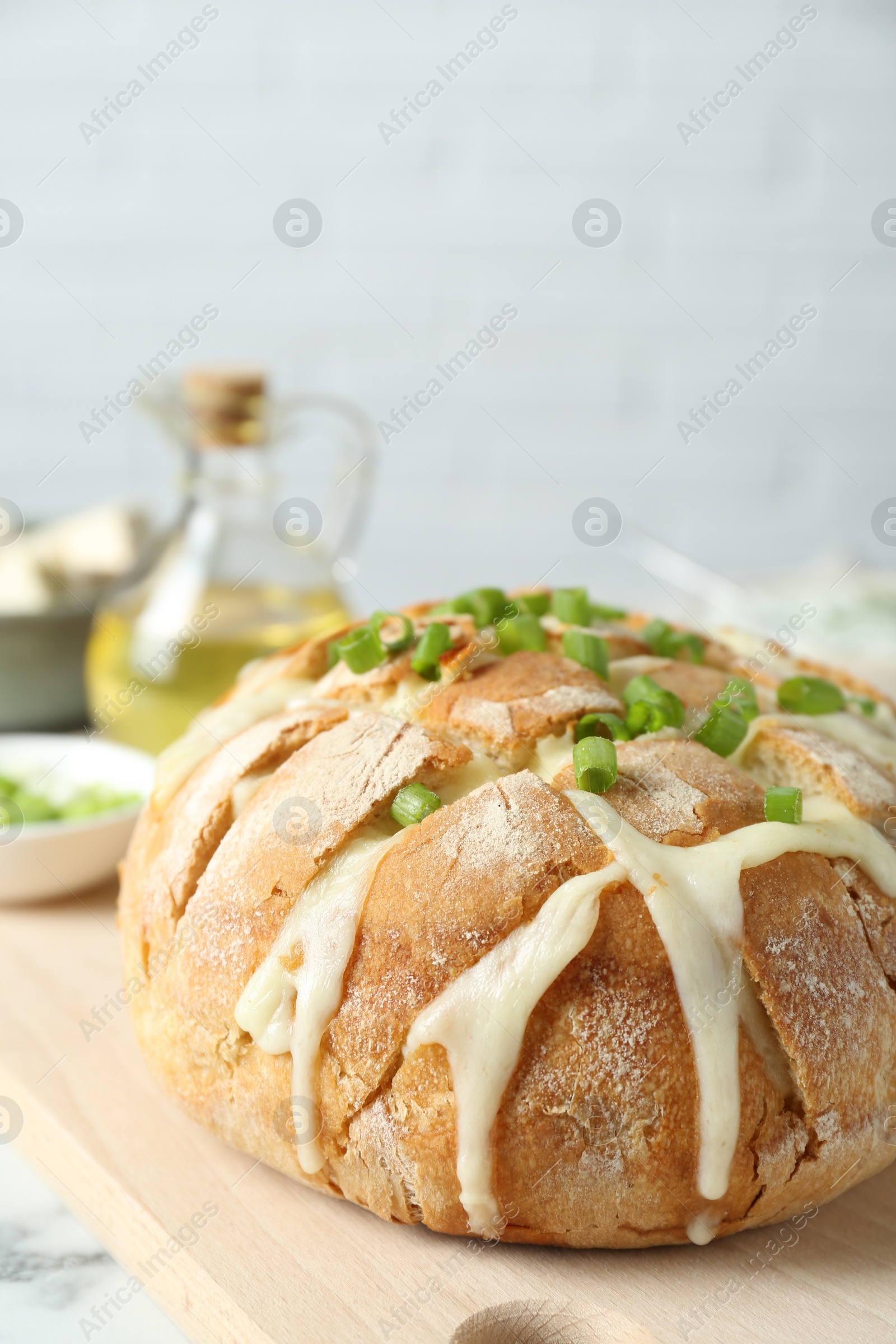 Freshly baked bread with tofu cheese and green onion on table Photo of Freshly baked bread with tofu cheese and green onion on table