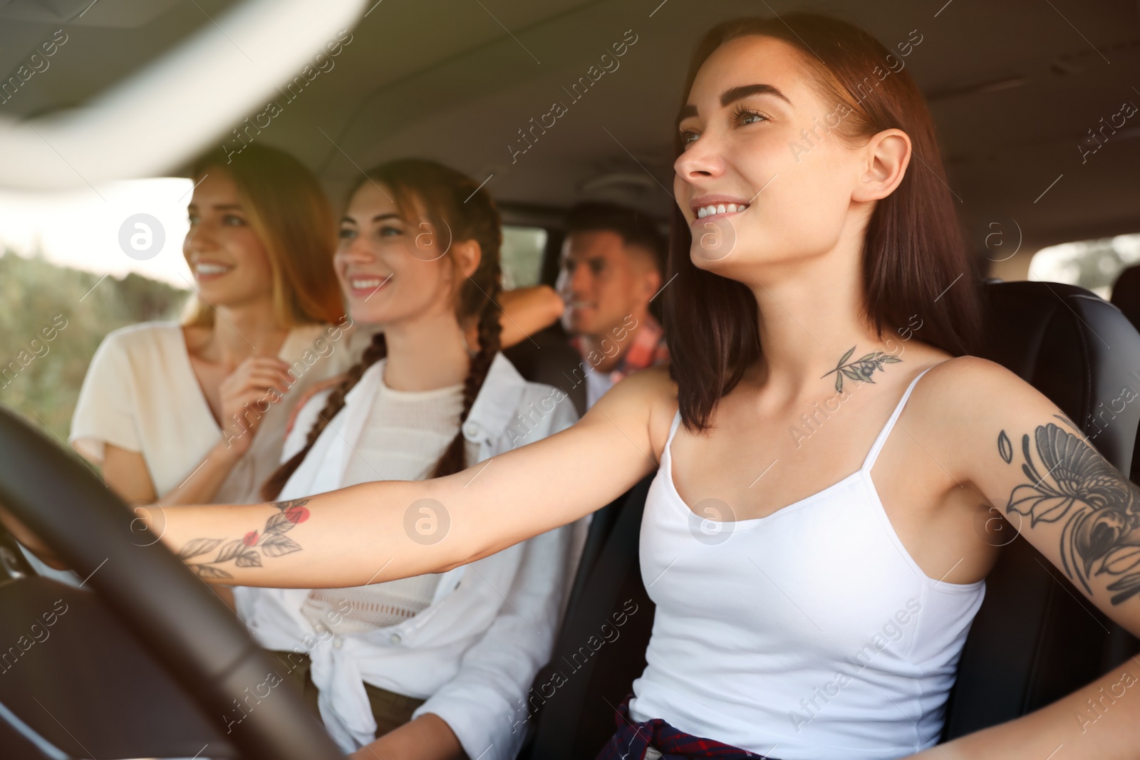 Photo of Happy friends together in car on road trip