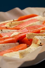 Slices of parsnip and carrot on baking tray, closeup