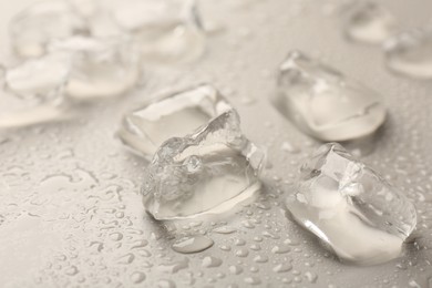 Photo of Pieces of crushed ice on grey background, closeup