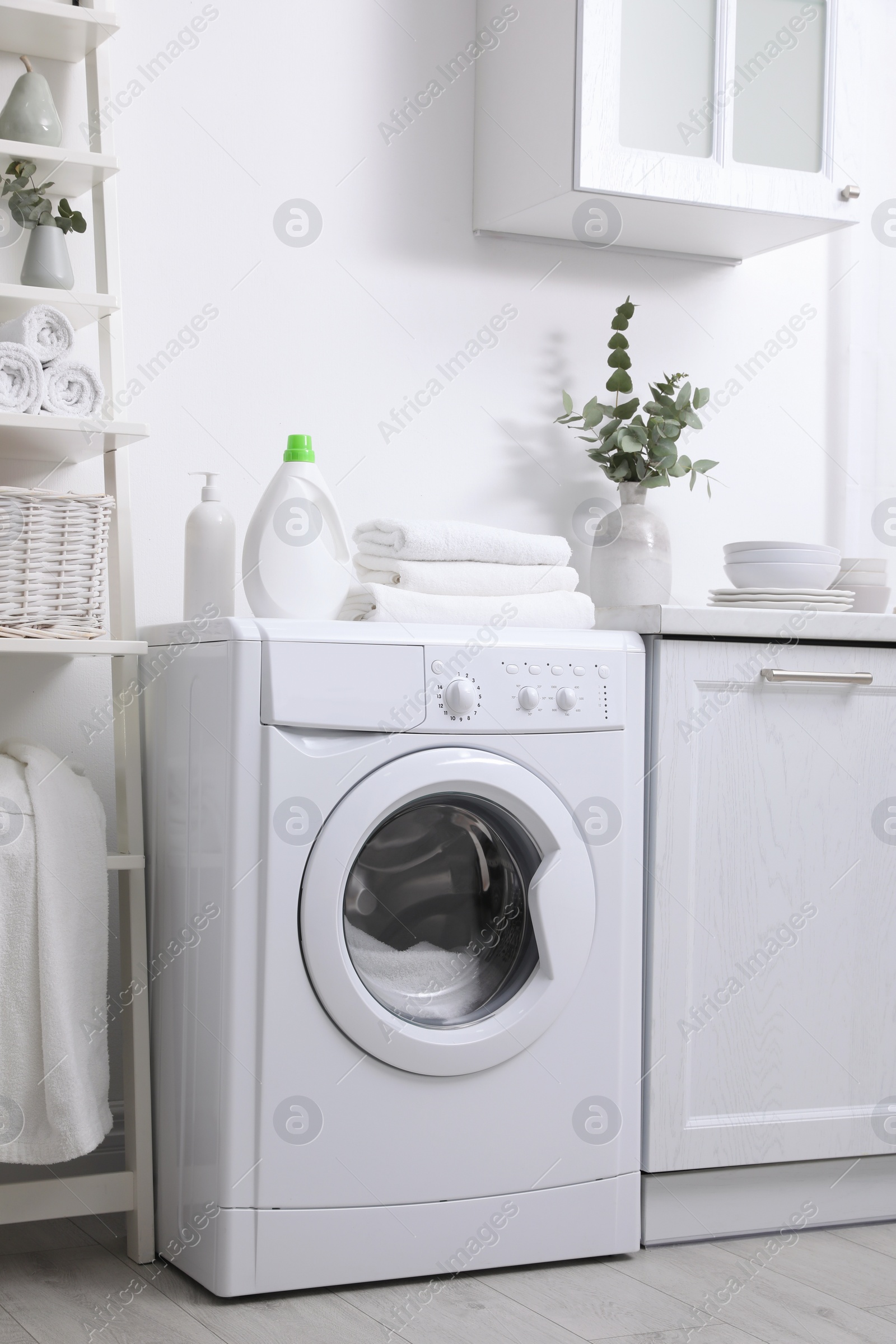Photo of Kitchen interior with washing machine and stylish furniture