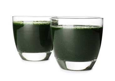 Photo of Glasses of spirulina drink on white background