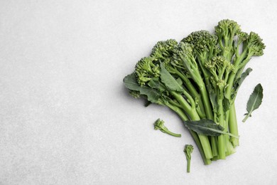 Photo of Fresh raw broccolini on white background, flat lay and space for text. Healthy food