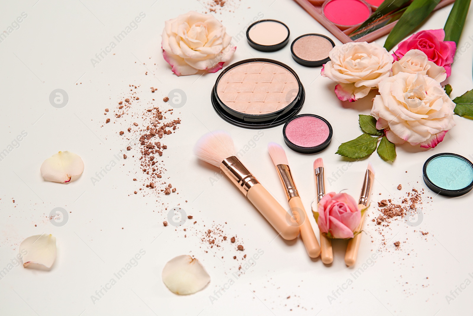 Photo of Composition with makeup brushes, cosmetic products and flowers on white background