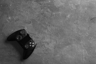 Photo of Modern video game controller on grey background, top view with space for text