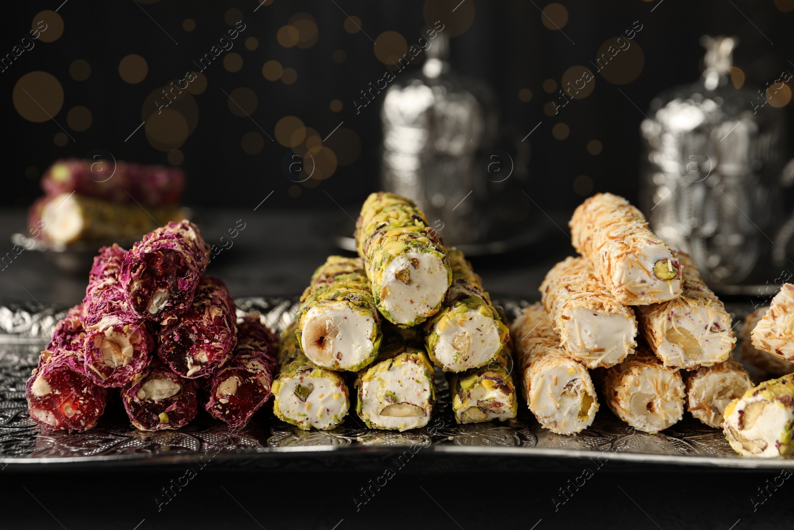 Photo of Turkish delight dessert on dark table. Traditional sweet