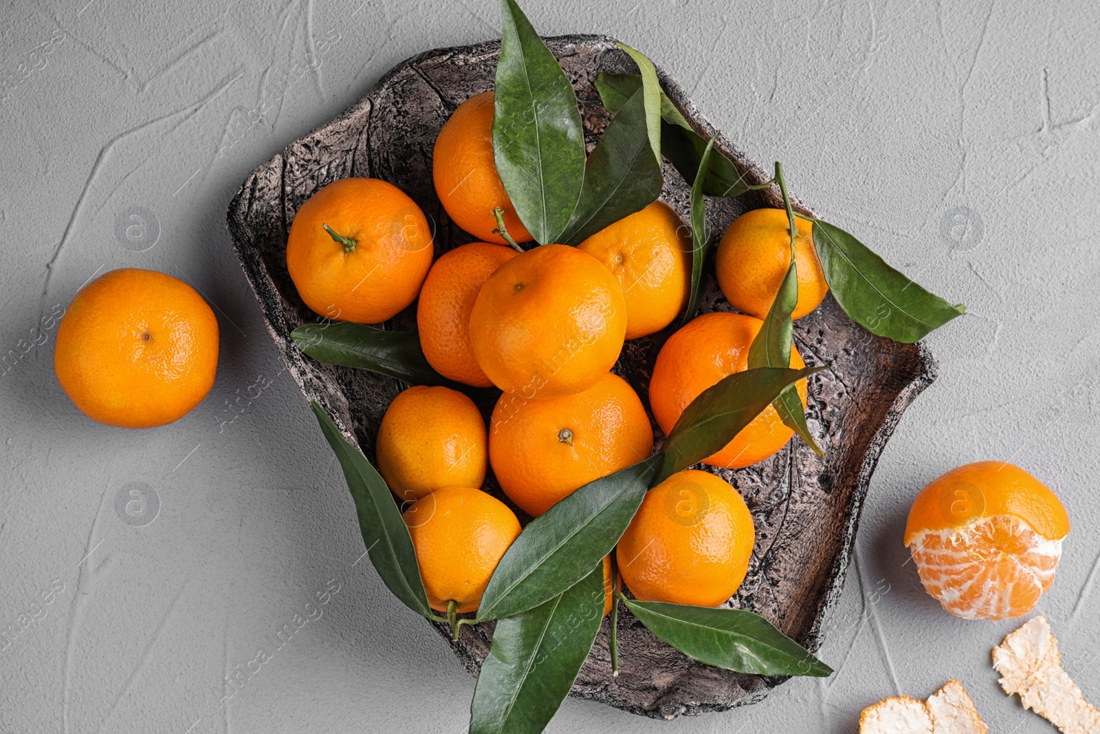 Photo of Fresh ripe tangerines on grey table, flat lay