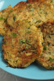 Delicious zucchini pancakes on grey table, closeup