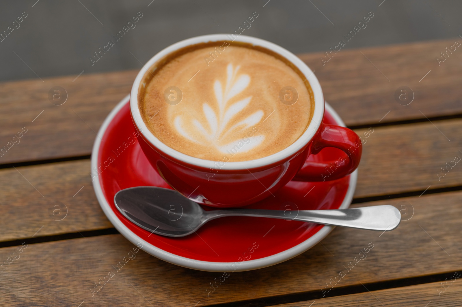 Photo of Cup of aromatic coffee on wooden table, closeup