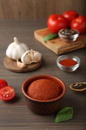 Photo of Red curry paste and ingredients on wooden table