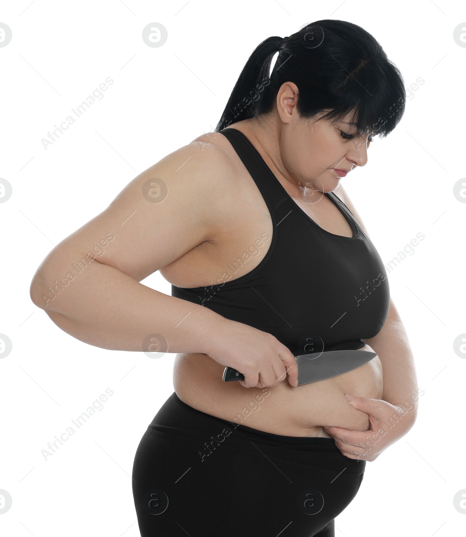 Photo of Obese woman with knife on white background. Weight loss surgery