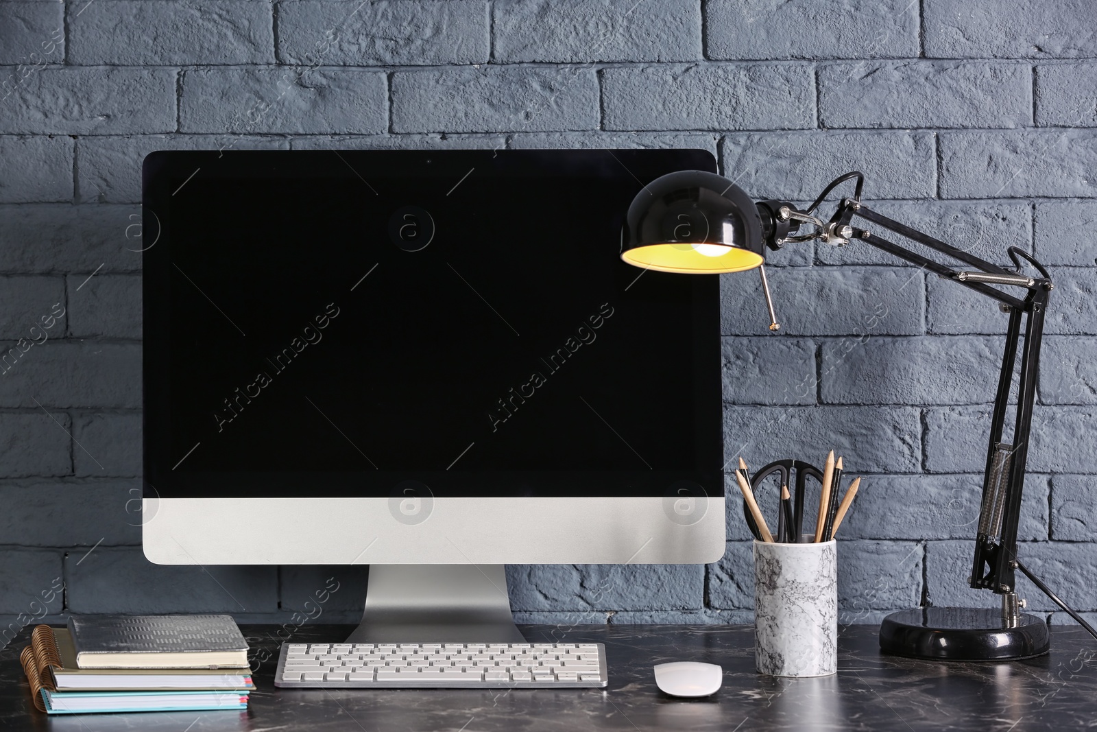 Photo of Computer with blank monitor on office table. Mock up for design