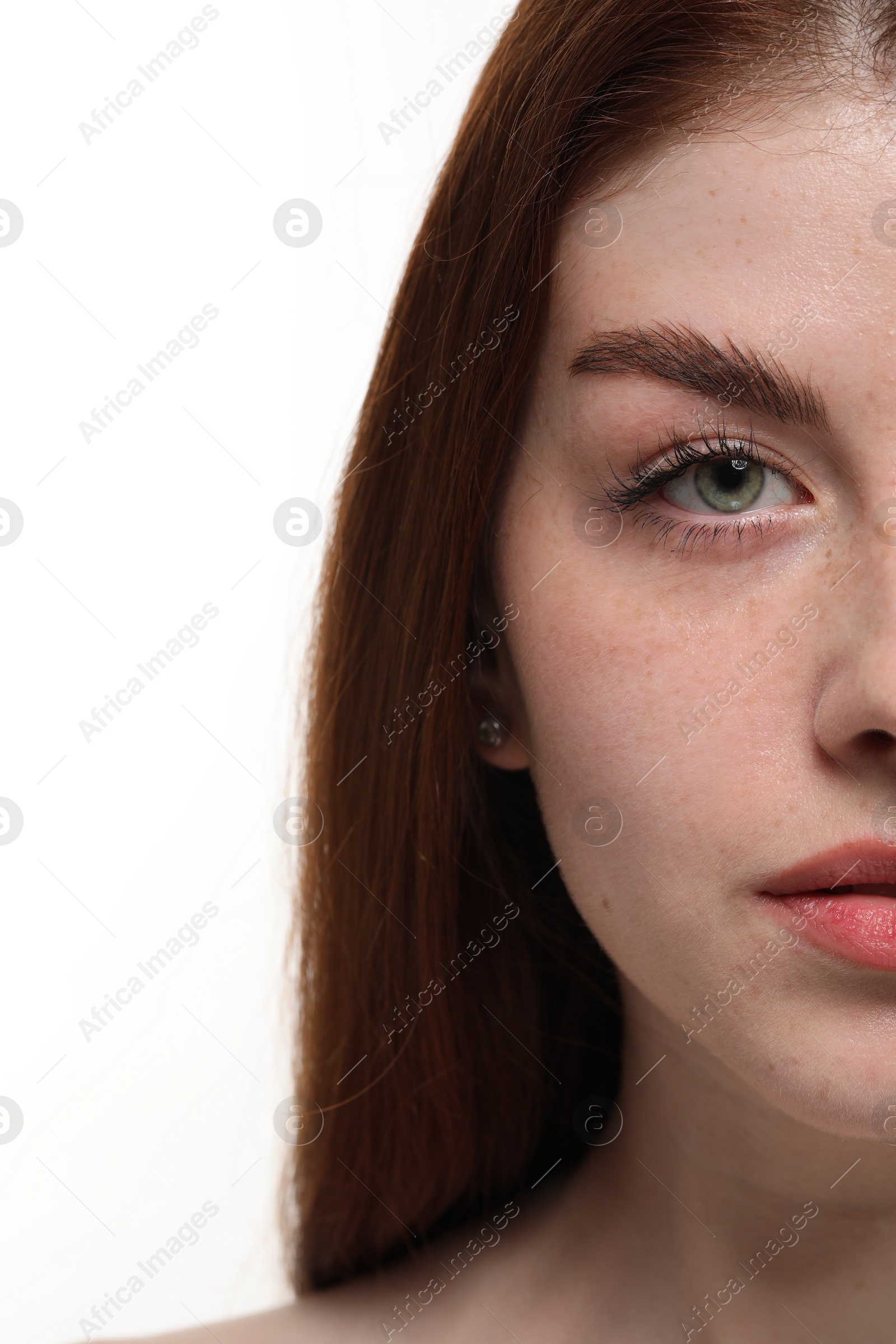 Photo of Beautiful woman with freckles on white background, closeup