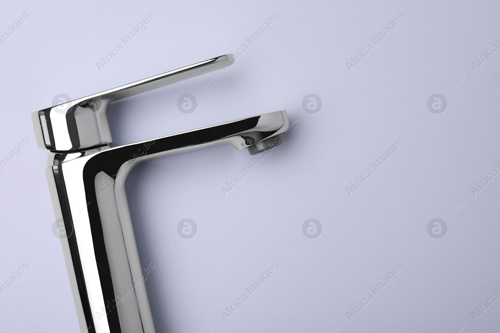 Photo of Single handle water tap on grey background, top view. Space for text