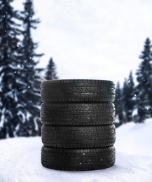 Image of Set of new winter tires outdoors on snow